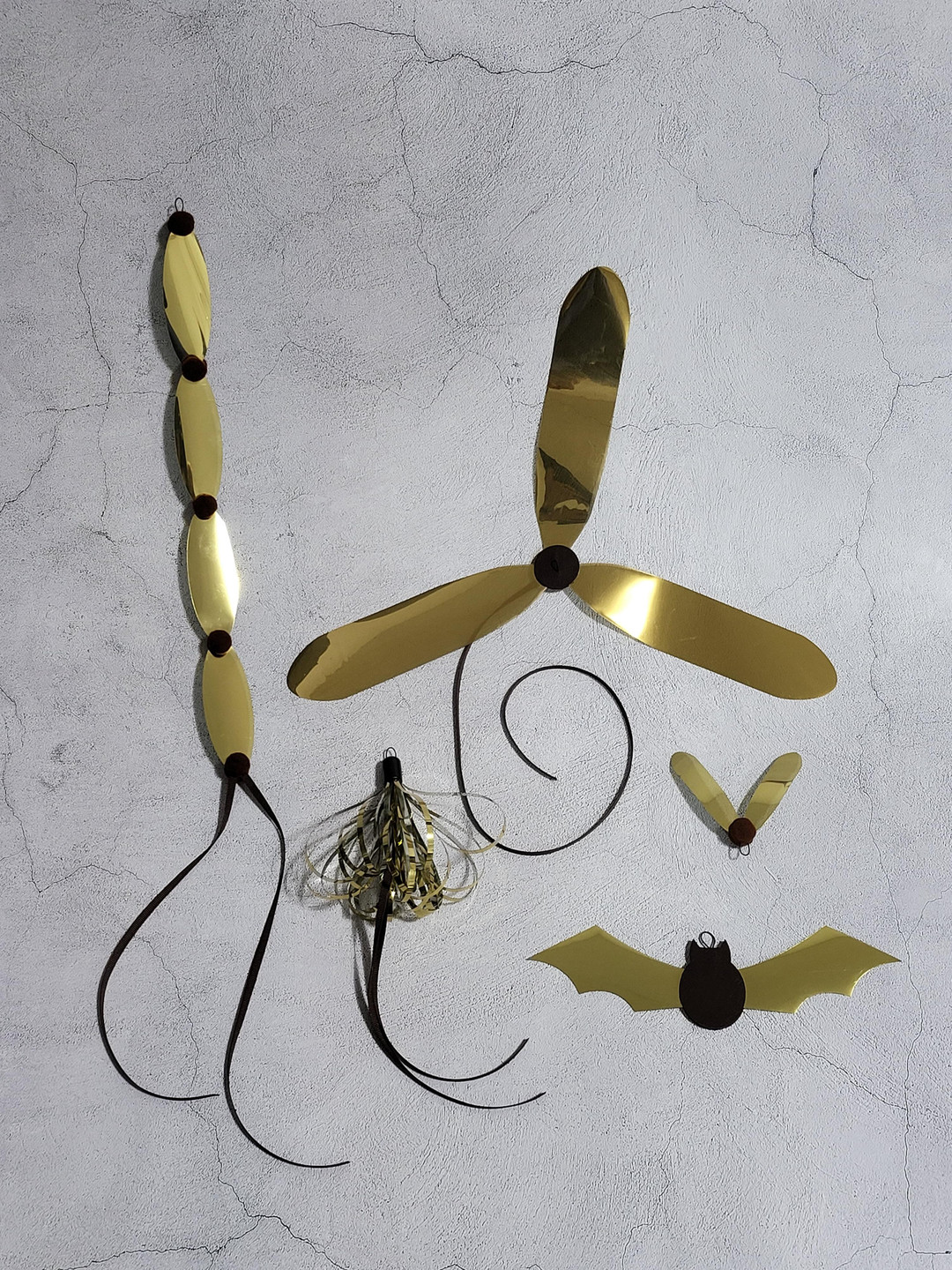 A collection of cat toys made of gold plastic